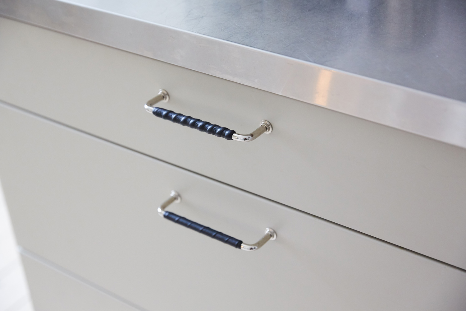 24481 Nærbilde av Ritzy kjøkkenhåndtak festet på to skuffer
